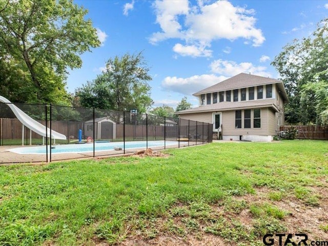 exterior space featuring a lawn and a fenced in pool