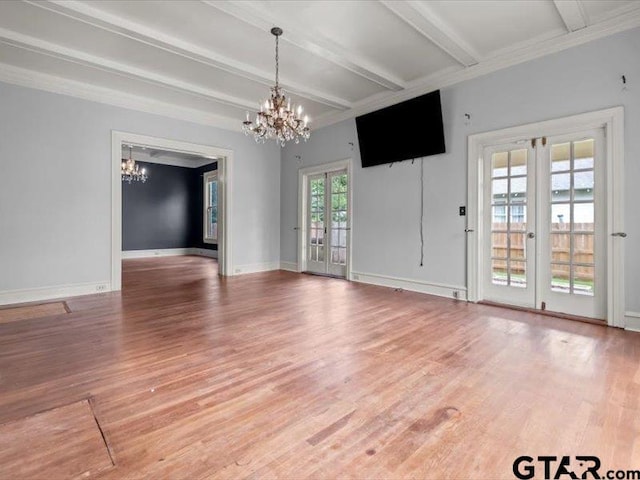 unfurnished room featuring hardwood / wood-style floors, beamed ceiling, and french doors