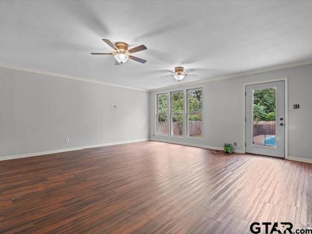 spare room featuring ornamental molding, dark wood-type flooring, and ceiling fan