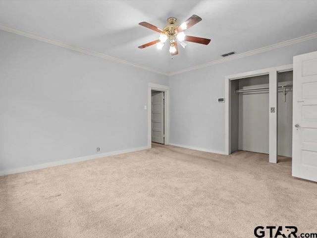 unfurnished bedroom featuring ceiling fan, crown molding, and light colored carpet