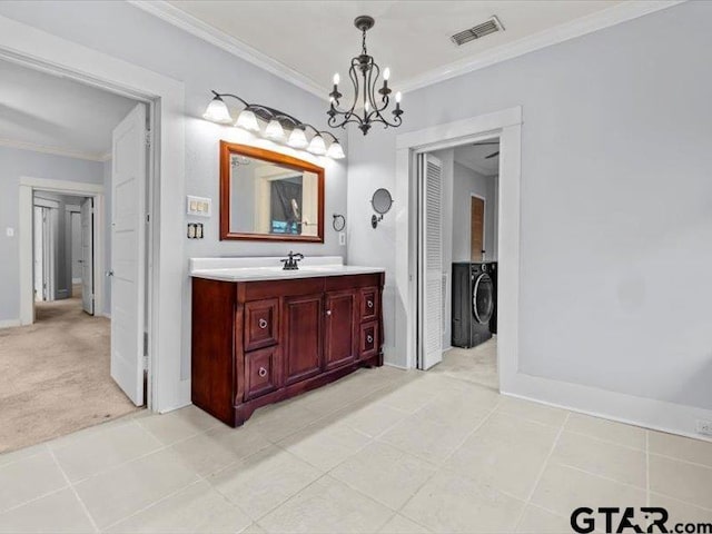 bathroom with vanity, an inviting chandelier, tile patterned floors, and crown molding