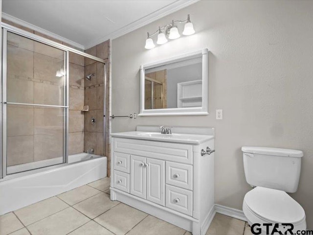 full bathroom featuring tile patterned flooring, ornamental molding, shower / bath combination with glass door, vanity, and toilet