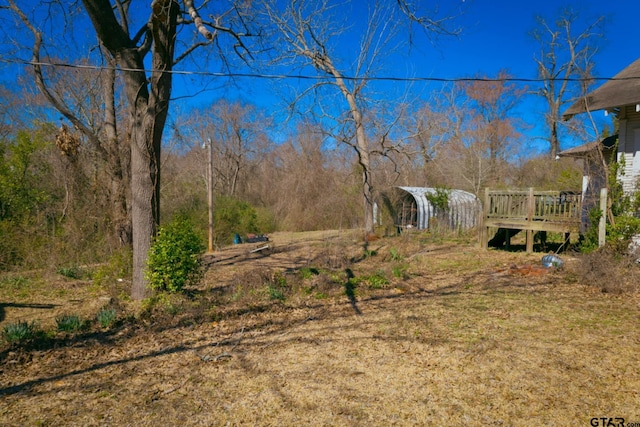 view of yard with a wooden deck