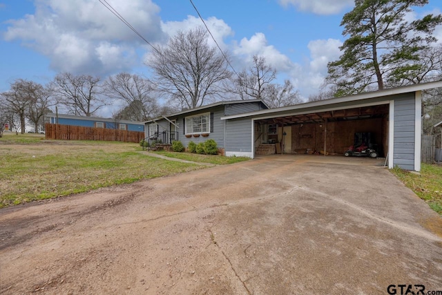 view of front of house with an attached garage, fence, driveway, and a front lawn