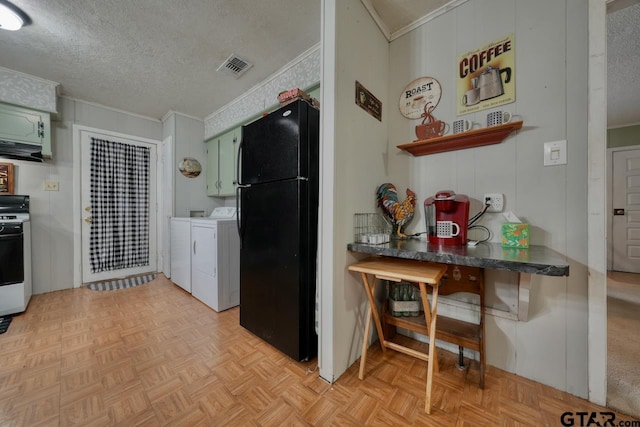 kitchen with crown molding, freestanding refrigerator, independent washer and dryer, and a textured ceiling