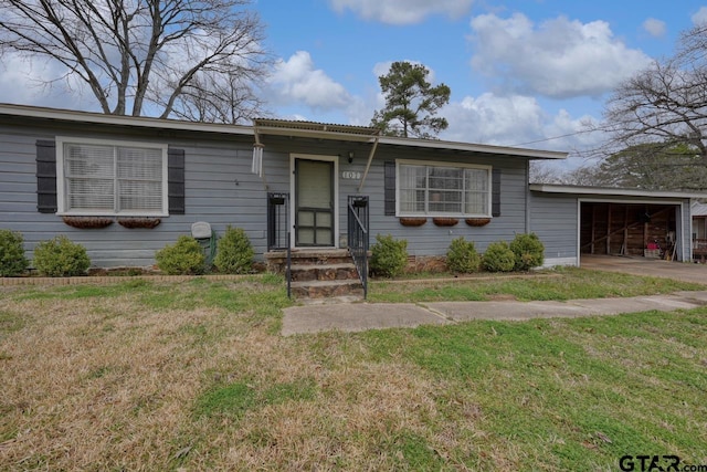 view of front of home with a garage and a front lawn