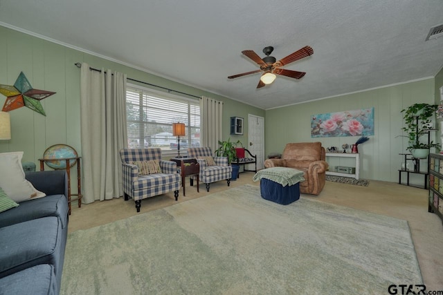 carpeted living room featuring visible vents, crown molding, a textured ceiling, and ceiling fan