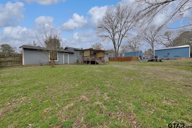 view of yard featuring a deck and fence