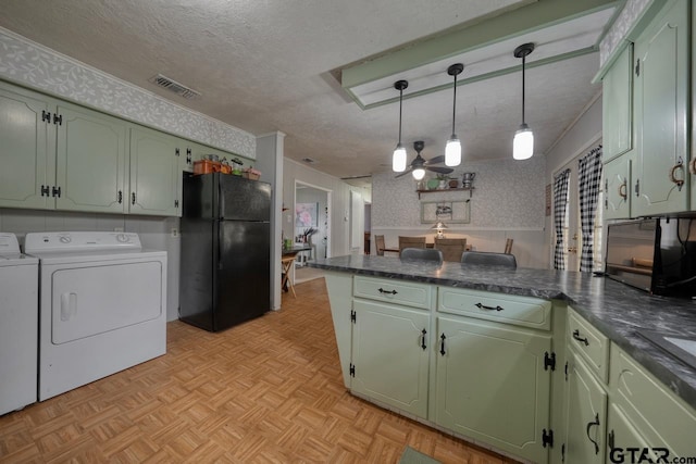 kitchen with freestanding refrigerator, a peninsula, green cabinets, and wallpapered walls