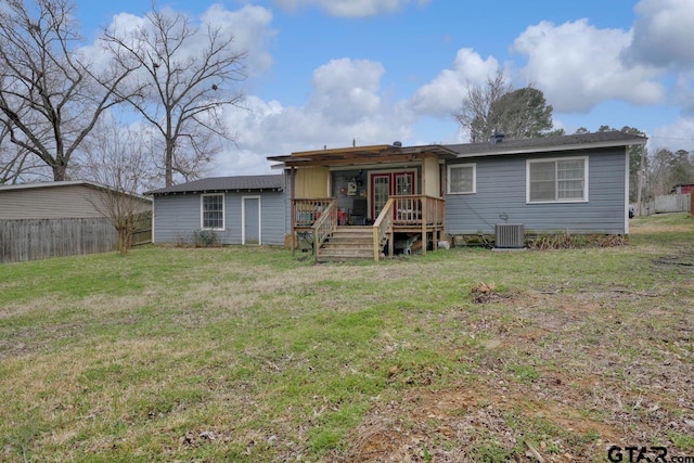 view of front facade featuring a front yard, fence, central AC, and a wooden deck