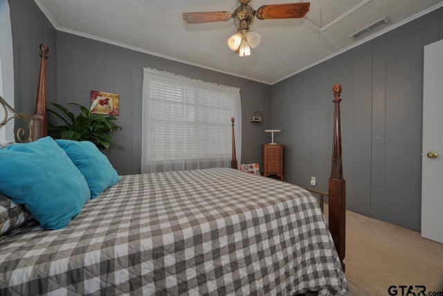 bedroom featuring ceiling fan, carpet flooring, visible vents, and crown molding