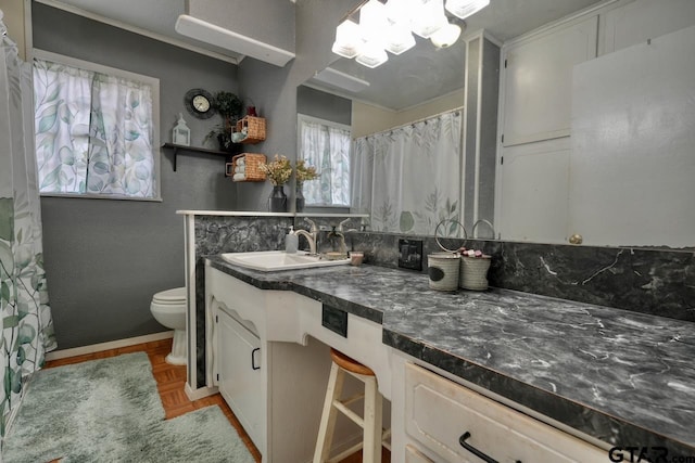 bathroom with toilet, curtained shower, and vanity