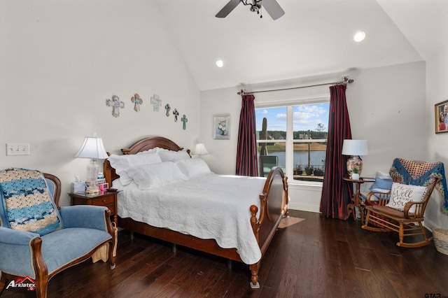 bedroom featuring dark hardwood / wood-style flooring, ceiling fan, a water view, and lofted ceiling