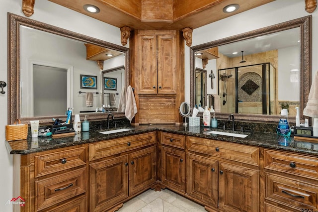 bathroom with vanity and a shower with door