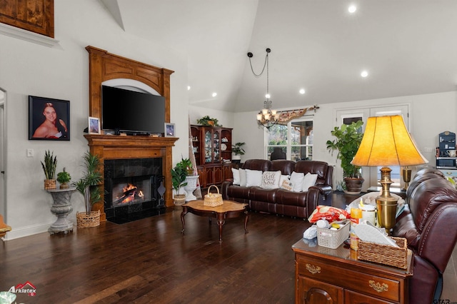 living room featuring a fireplace, lofted ceiling, a chandelier, and dark hardwood / wood-style flooring