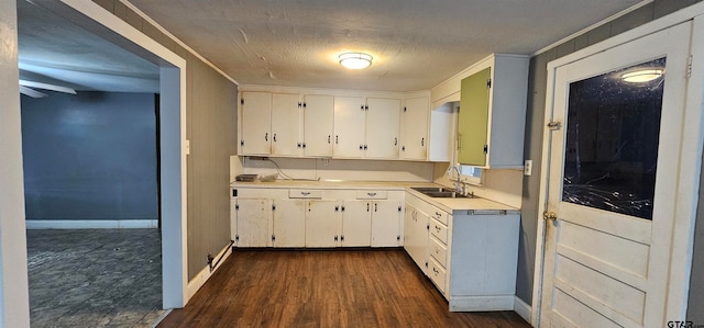 kitchen with white cabinets, sink, dark hardwood / wood-style flooring, and ornamental molding