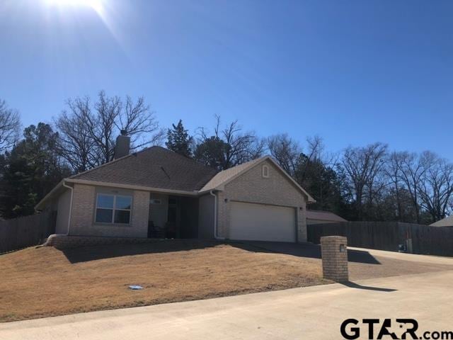14160 Donna Dr, Brownsboro, TX 75756 - ranch-style house with a garage, brick siding, driveway, and fence