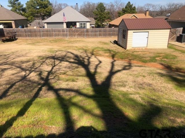 view of yard with a storage shed and central AC unit