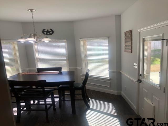 dining room featuring a healthy amount of sunlight and a chandelier