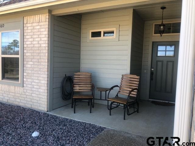 entrance to property featuring a patio area