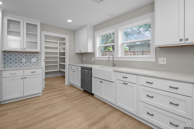 601 N 4th St, Crockett, TX 75835 - kitchen featuring dishwasher, a sink, tasteful backsplash, white cabinetry, and light wood finished floors