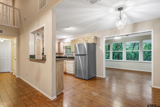 141 Green Mesa Ln, Holly Lake Ranch, TX 75765 - kitchen featuring freestanding refrigerator, white dishwasher, dark countertops, and wood-type flooring
