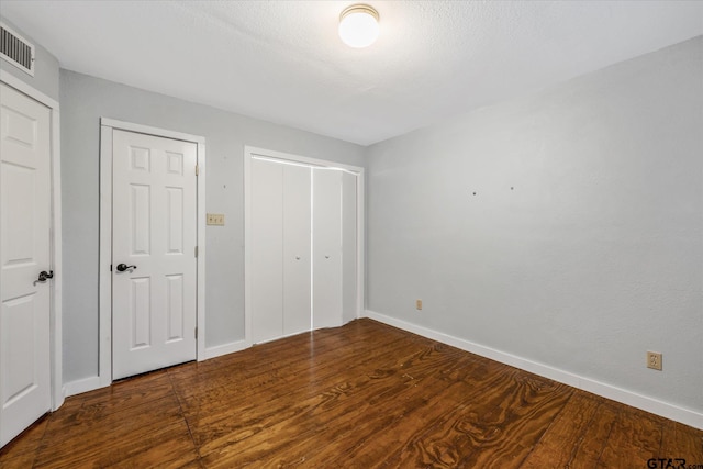 141 Green Mesa Ln, Holly Lake Ranch, TX 75765 - unfurnished bedroom with baseboards, wood finished floors, and a closet