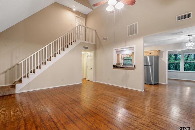 141 Green Mesa Ln, Holly Lake Ranch, TX 75765 - unfurnished living room featuring high vaulted ceiling, stairway, baseboards, ceiling fan, and hardwood / wood-style flooring