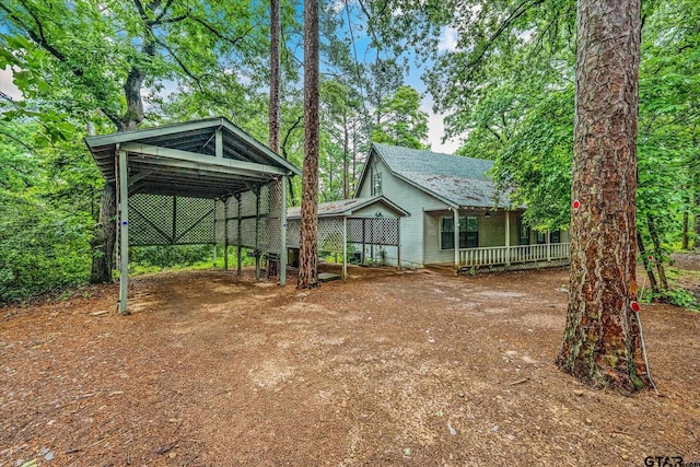 141 Green Mesa Ln, Holly Lake Ranch, TX 75765 - view of yard featuring driveway, a carport, and a porch