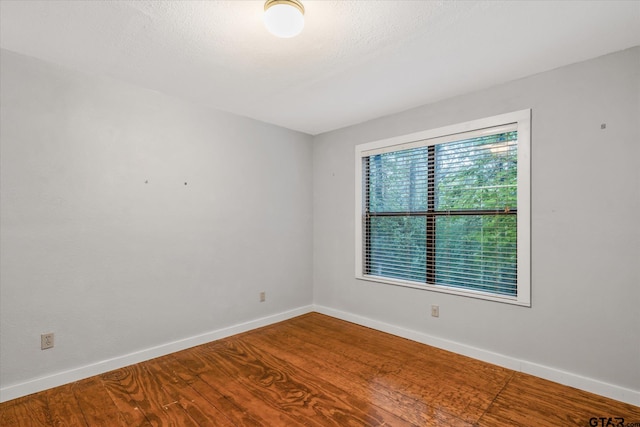 141 Green Mesa Ln, Holly Lake Ranch, TX 75765 - spare room featuring baseboards and wood finished floors