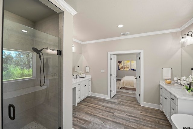 bathroom with wood-type flooring, vanity, and ornamental molding