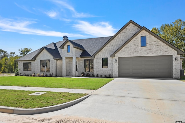 french provincial home with central AC, a garage, and a front lawn