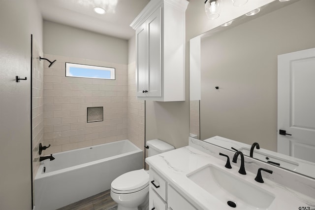 full bathroom featuring hardwood / wood-style flooring, vanity, toilet, and tiled shower / bath