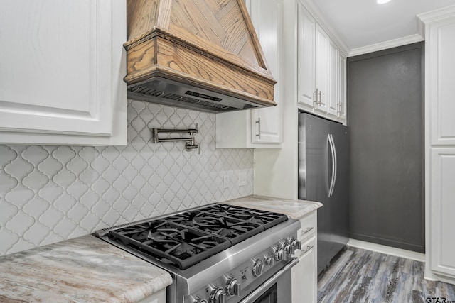 kitchen with white cabinets, custom range hood, appliances with stainless steel finishes, and dark wood-type flooring