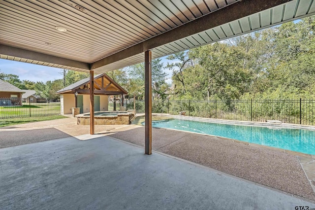 view of swimming pool featuring a patio and an in ground hot tub