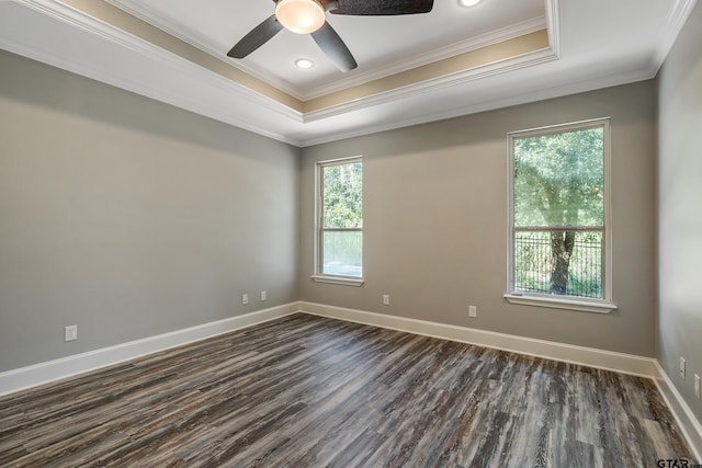 unfurnished room featuring dark wood-type flooring, ornamental molding, ceiling fan, and a healthy amount of sunlight