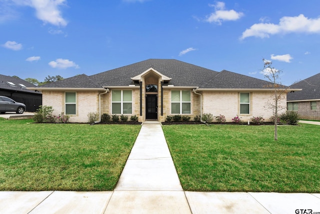 7923 Crooked Trl, Tyler, TX 75703 - view of front of property with a front lawn, brick siding, and roof with shingles