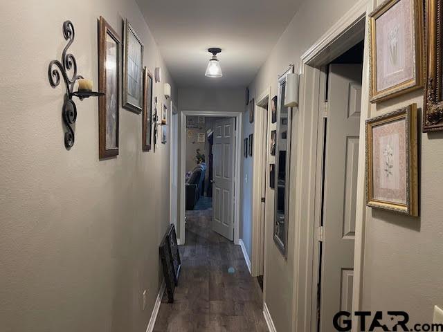 corridor featuring dark wood-type flooring