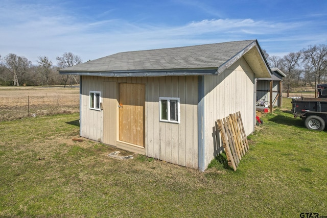 view of outbuilding with a yard