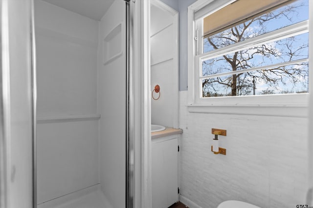 bathroom featuring a stall shower and vanity