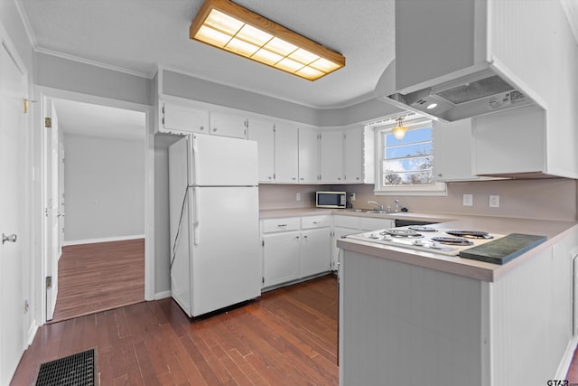 kitchen with dark wood-style floors, visible vents, white cabinets, wall chimney range hood, and white appliances