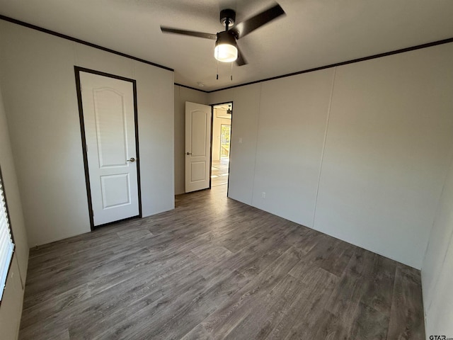 unfurnished bedroom featuring ceiling fan, hardwood / wood-style floors, and crown molding