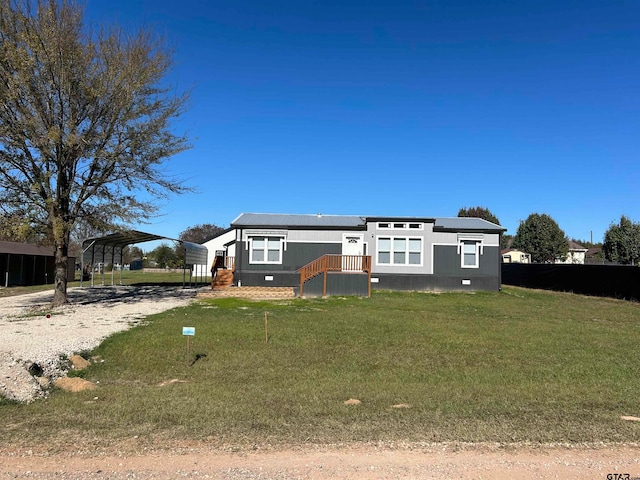 view of front facade featuring a front lawn and a carport