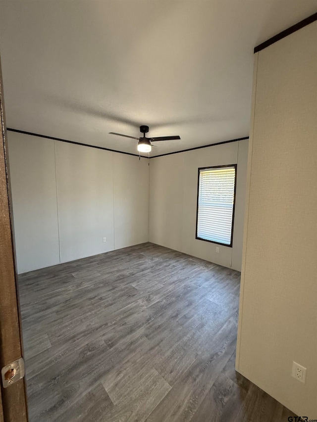 empty room with hardwood / wood-style floors and ceiling fan