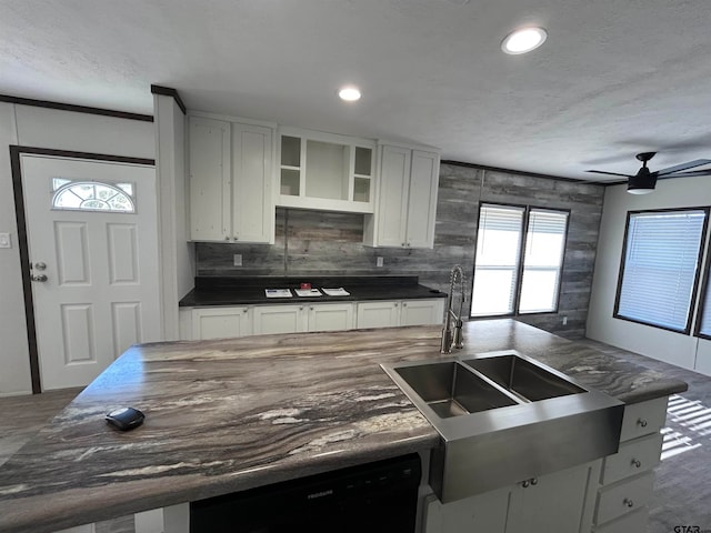 kitchen featuring backsplash, ceiling fan, sink, white cabinets, and black dishwasher