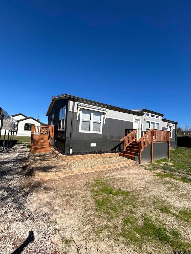 back of property featuring a wooden deck