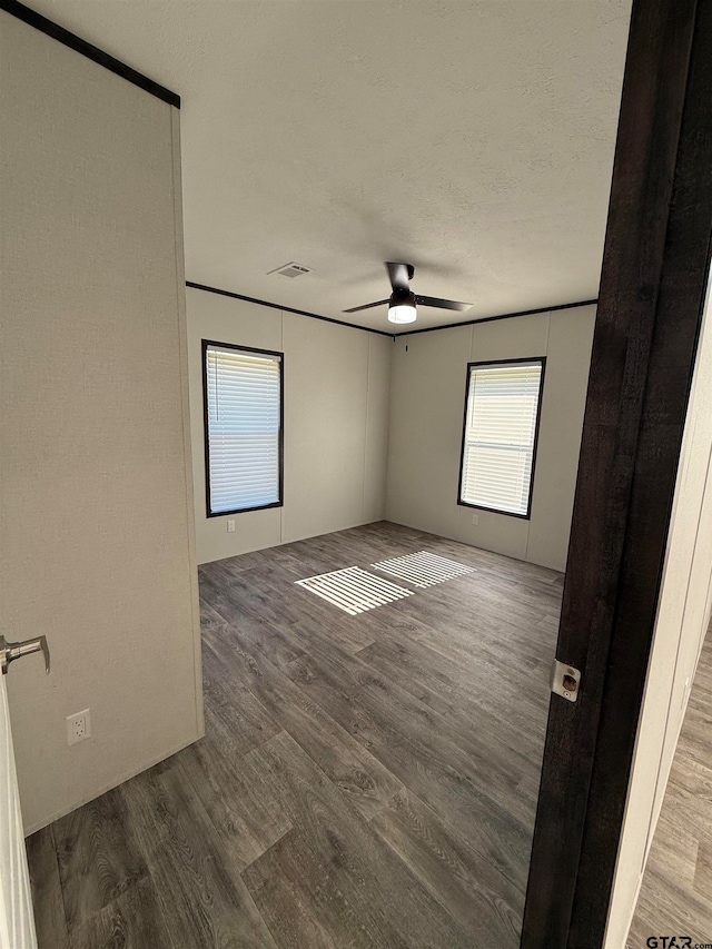 unfurnished room with hardwood / wood-style floors, a textured ceiling, and ceiling fan