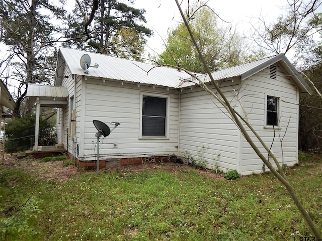 rear view of property with a lawn