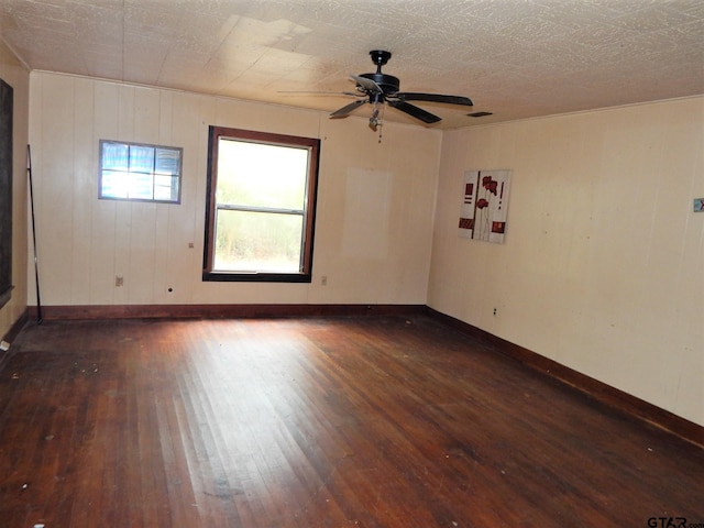 unfurnished room featuring ceiling fan and dark hardwood / wood-style floors