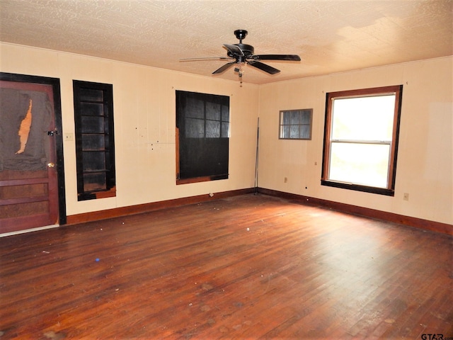 spare room with ceiling fan and dark hardwood / wood-style floors